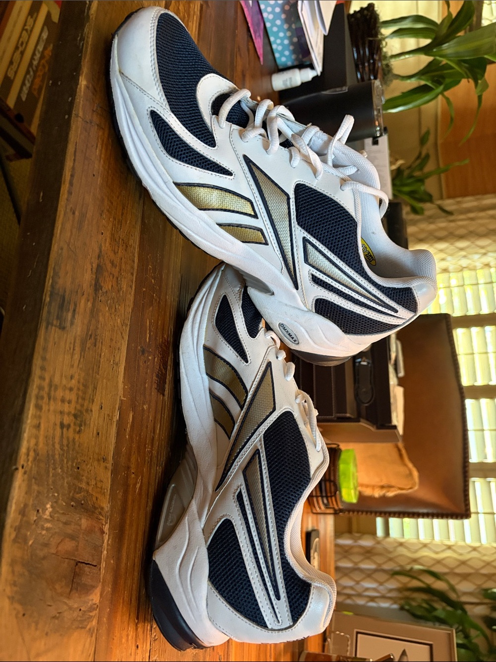 Like New Reebok size 10.5 Men's White and Navy Athletic Sneakers with Gold Accen